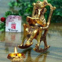 Golden Lord Ganesha Sitting On A Rocking Chair